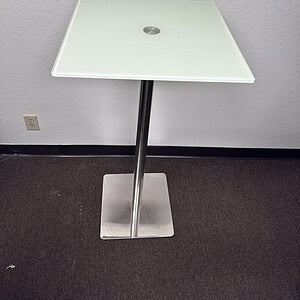 Frosted glass 2x2 bar height table with metal stand, ideal for contemporary interiors.