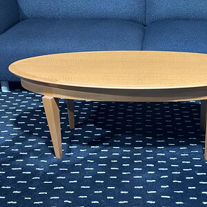 Honey Maple 4ft by 20in occasional table with elegant design and natural wood finish.