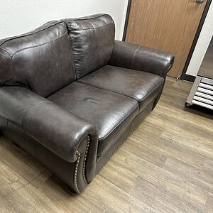 Leather love seat for living room comfort and style.