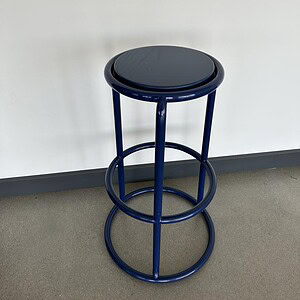Blue metal stool with three different height options for versatile seating.