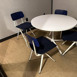White round table for office or conference room use.