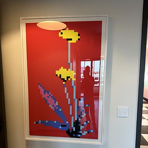 Inspired pixel flower artwork on a red background.