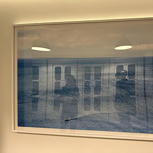 Framed ocean scene with a solo boat, perfect for coastal decor.