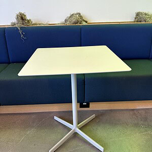 Modern white square metal table with sleek design, ideal for cafes and offices.