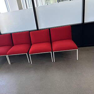 Red soft seat chair with steel base, ideal for office or waiting areas. Modern design and durable co.