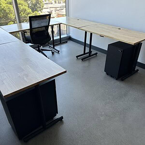 Versatile 8x8 U-shaped modular desks with sturdy wood surfaces and black metal frames, ideal for col.