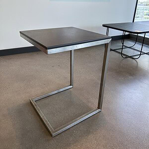 Shape steel and grey finish occasional table, modern design for living rooms or offices.