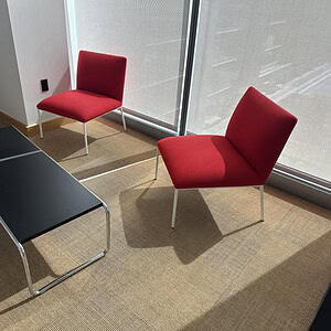 Modern black rectangular occasional table in office lounge setting.