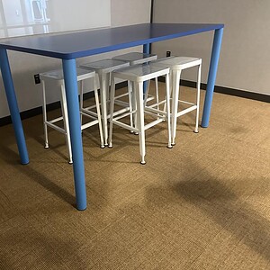 Blue bar height table for commercial or home use, ideal for cafes, bars, and social spaces. Durable.