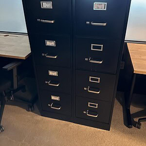 Black vertical file cabinets for office storage and organization.