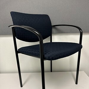 Navy blue Steelcase Player guest chair with black metal frame and armrests. Ideal for office waiting.
