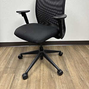 Ergonomic office chair with black mesh back and adjustable armrests, ideal for comfortable workspace.