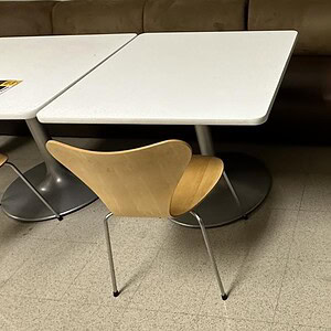 Modern Steelcase 3x3 white square table with steel base and wooden chair.