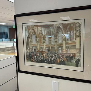 Framed artwork of the New York Stock Exchange interior, showcasing historic trading floor scenes.