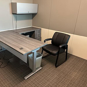 Adjustable desk with Driftwood finish and sturdy pedestal base.