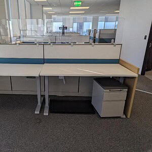 Herman Miller 58x29in HAT table with white top in modern office setting.