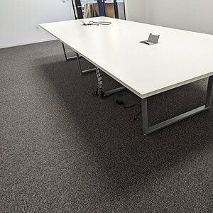 Modern Herman Miller 14x5 foot steel powered conference table in office setting.