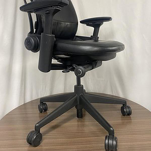 Black Leather Steelcase Leap V2 ergonomic office chair with adjustable features.