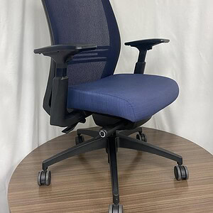 Ergonomic navy blue office chair with adjustable armrests and wheels for comfort and mobility.