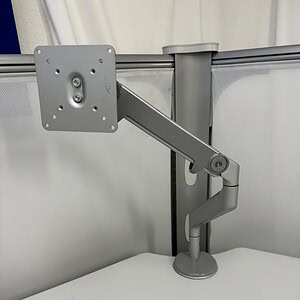 Adjustable monitor arm by Humanscale, perfect for ergonomic workspace setups and monitor positioning.