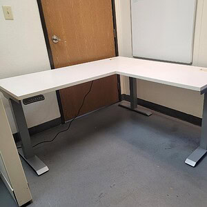 Adjustable 5x5 white electric desk for ergonomic workspace comfort and flexibility.