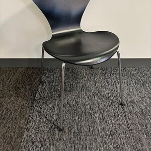 Black Fritz Hansen veneer stacking chair for modern interiors.
