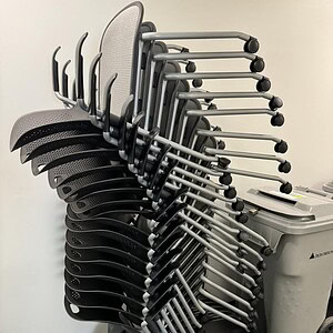 Stack of Herman Miller Caper stacking chairs for office or conference room use.