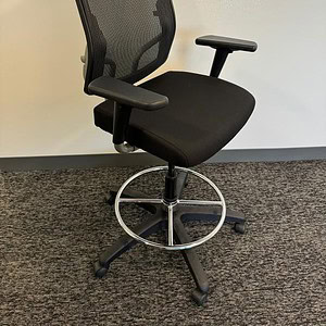 Ergonomic black stool chair with mesh back and pneumatic height adjustment.