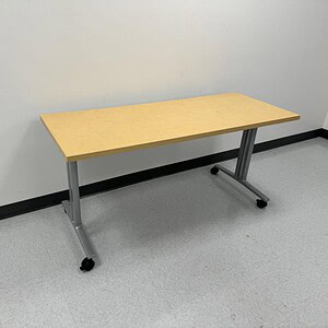 Herman Miller mobile nesting table with wood top and metal legs, versatile office furniture.
