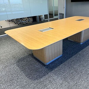 Modern Herman Miller conference table with built-in power outlets.