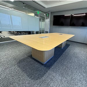 Veneer conference table by Herman Miller in modern office setting.
