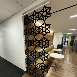 Black acoustical wall hanger upmounted for sound absorption and decor.