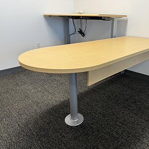 Modern Bullet Shape Maple Desk with sturdy metal leg, ideal for office workspaces.