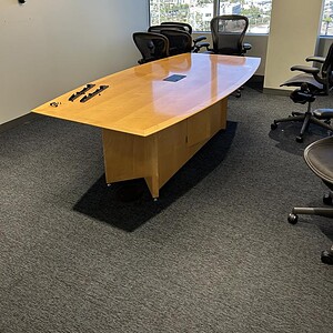 Maple veneer 8x4 boat shape conference table in modern office setting.