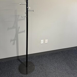 Industrial steel coat hanger with multiple hooks for hanging coats and accessories.