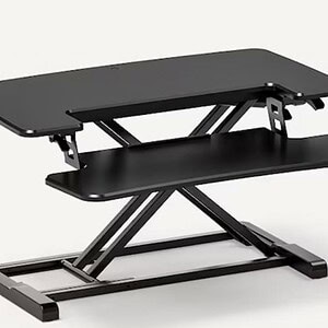 Adjustable standing desk converter for ergonomic workspace setup.