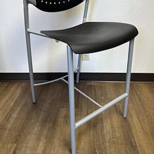 Keilhauer black perforated stool with metal base, modern office seating.