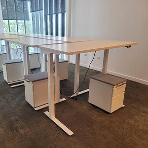 Herman Miller 60x30-inch HAT white table with mobile pedestal for versatile office workspace.