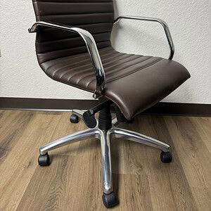 Brown vinyl office chair with chrome arms and base, ergonomic design.