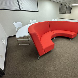 Red half circle bar stool for modern office or lounge spaces.