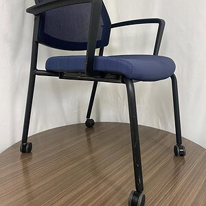 Blue stacking chair with casters, ergonomic design, ideal for office or conference rooms.