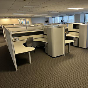 Office cubicles with private workspaces in a modern corporate environment.