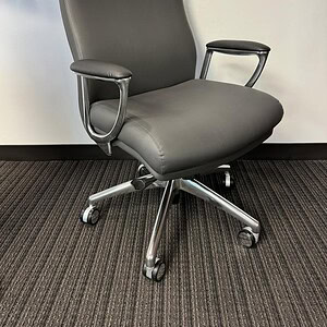 Grey leather office chair with adjustable armrests and ergonomic design.