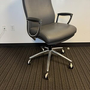 Grey leather high back office chair with adjustable armrests and chrome base.