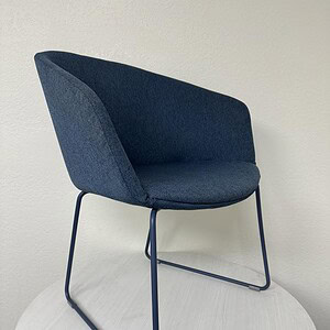 Stylish blue sled bucket chair with metal frame, ideal for lounge, office, or waiting areas.