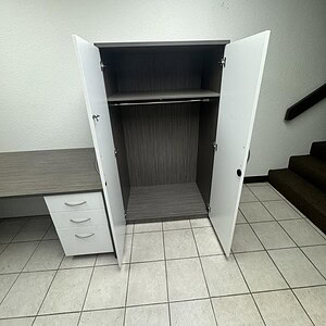 Modern OFS 36in wide x 65in tall storage wardrobe with open doors.