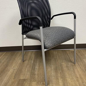 Mesh back guest chair with armrests, ideal for waiting areas and offices.