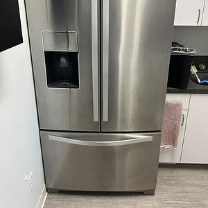 Efficiency Whirlpool refrigerator with built-in ice maker, stainless steel finish, and spacious stor.