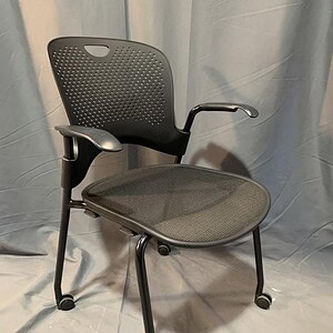 Herman Miller Caper ergonomic office chair with adjustable armrest and casters.