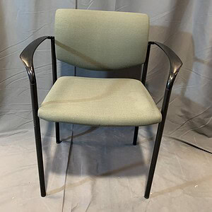Stacking office chair with light green fabric and black metal frame.